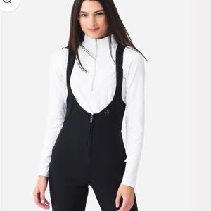 Obermeyer black softshell pants with suspenders and stirrups. High waisted